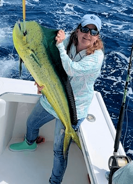 Lady angler catches monster mahi.