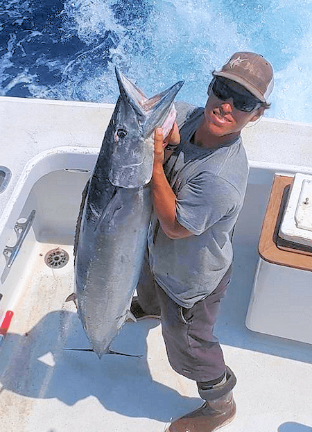 Derek Wood holding huge wahoo on charter trip.